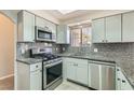 Well-lit kitchen featuring modern appliances, gray cabinets, and granite countertops at 508 Indian Princess Dr # 104, Las Vegas, NV 89145