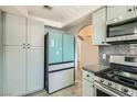 Bright kitchen boasts modern stainless steel appliances and gray cabinets, backsplash and flooring at 508 Indian Princess Dr # 104, Las Vegas, NV 89145