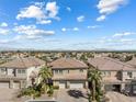 An aerial view of houses with clay tile roofs and well-maintained landscaping in a suburban setting at 5578 Holcomb Bridge Ct, Las Vegas, NV 89149