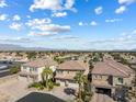 Expansive view of a residential neighborhood with uniform architecture, palm trees, and mountain backdrop at 5578 Holcomb Bridge Ct, Las Vegas, NV 89149