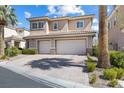 Charming two-story house featuring a two-car garage, paved driveway, and lush landscaping at 5578 Holcomb Bridge Ct, Las Vegas, NV 89149