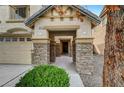 Inviting front porch with stone columns and decorative detailing, offering a warm welcome to this lovely home at 5829 Feral Garden St, North Las Vegas, NV 89031