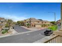 Neighborhood street view showcases well-maintained homes with desert landscaping and a clear view of the sunny sky at 5829 Feral Garden St, North Las Vegas, NV 89031
