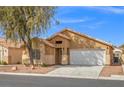 Inviting single-story home with desert landscaping and a two-car garage at 6037 Soft Springs Ave, Las Vegas, NV 89130