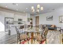 Modern kitchen with white cabinets, stainless steel appliances, quartz countertop, and adjacent dining area at 762 Lilac Oak St, Henderson, NV 89011
