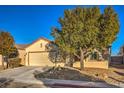 Inviting single-story residence featuring a xeriscaped front yard and an attached two car garage at 7824 Homing Pigeon St, North Las Vegas, NV 89084