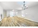 Bright living room with wood floors, lots of windows and a modern chandelier at 8646 Mesquite Hills St, Las Vegas, NV 89139
