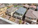 Aerial view showcasing the home's roof, surrounding neighborhood, and proximity to a community playground at 8866 Mountain Lion Ave, Las Vegas, NV 89166