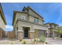 Modern two-story home with stone accents, desert landscaping, and a brick-paved driveway leading to the garage at 8866 Mountain Lion Ave, Las Vegas, NV 89166