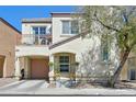Charming two-story home boasts a covered porch, balcony, and attached garage at 8868 Intertwine, Las Vegas, NV 89149