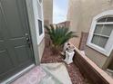 Entrance featuring a well-maintained flower bed, a welcoming front door, and a lovely, decorative mat at 9126 Haddington Ln, Las Vegas, NV 89145