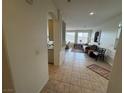 Inviting living room with tile flooring, lots of light from the large windows, and mountain views at 9126 Haddington Ln, Las Vegas, NV 89145