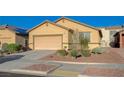 Traditional one story home with desert landscaping, a two car garage and neutral color palette at 980 Aspen Cliff Dr, Henderson, NV 89011