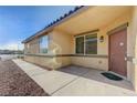 Home exterior featuring a front door with a porch and desert landscaping at 980 Aspen Cliff Dr, Henderson, NV 89011