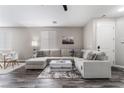 Bright living room featuring a large sectional sofa, modern decor, and stylish flooring at 7940 Violet Dawn St, Las Vegas, NV 89149