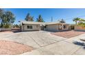 Desert-landscaped single story house with large driveway and well-maintained exterior at 1900 E Oakey Blvd, Las Vegas, NV 89104