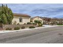 Inviting single-story residence showcasing desert landscaping, a tile roof, and a two-car garage at 2148 Shadow Canyon Dr, Henderson, NV 89044