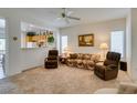 Bright living room featuring neutral carpet, ceiling fan, and lots of natural light at 2194 King Mesa Dr, Henderson, NV 89012