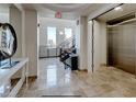 Well-lit hallway with a staircase, elevator access, and tiled floors at 2240 Village Walk Dr # 2207, Henderson, NV 89052