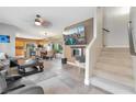 Open-concept living room featuring tile floors, modern decor, a fireplace, and staircase at 2293 Bull Lake Dr, Henderson, NV 89052