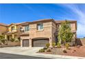 Attractive two-story home with a tile roof, desert landscaping, and an attached two-car garage at 260 Pioneers Peak, Henderson, NV 89002