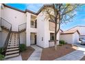 Two-story condo building featuring balconies, iron railings, earth-toned stucco, and desert landscaping at 2615 W Gary Ave # 1089, Las Vegas, NV 89123