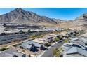 Picturesque aerial view of a Primary-planned community nestled at the base of the mountains at 2931 Raywood Ash Dr, Las Vegas, NV 89138