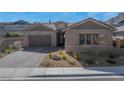 Charming single-story home with a two-car garage, beautiful stone accents, and desert landscaping at 2931 Raywood Ash Dr, Las Vegas, NV 89138