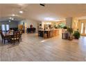 Spacious open floor plan featuring tile floors, a large center island, and dining area at 3132 El Camino Rd, Las Vegas, NV 89146