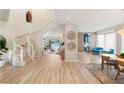 Spacious foyer with a winding staircase, wood-look floors, and an open floor plan to the kitchen and living area at 3173 Lido Isle Ct, Las Vegas, NV 89117