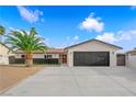 Inviting single-story home boasts a new driveway, a dark accent brick wall, and a beautiful mature palm tree at 3228 Robin Cir, Las Vegas, NV 89121