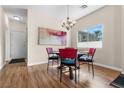 Cozy dining area with modern chandelier and large window with neighborhood views at 3405 Robust Robin Pl # 3, North Las Vegas, NV 89084