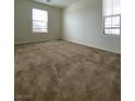 Bright bedroom features carpet flooring, large windows and a neutral color palette at 346 Andy Wheeler Dr, Henderson, NV 89011
