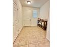 Welcoming entryway with tiled flooring, console table, and a view of the front door at 346 Andy Wheeler Dr, Henderson, NV 89011