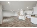 An expansive living room and kitchen area boasting recessed lighting, stainless appliances, and tile floors at 4040 Beech Fern Ave, North Las Vegas, NV 89084