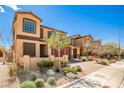 Beautiful two-story home featuring a two-car garage, well-kept landscaping, and a brick driveway at 4423 Creekside Cavern Ave, North Las Vegas, NV 89084