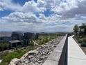 Scenic view of the community, showing multiple homes, landscaping, and mountain views at 492 Pear Lake St, Las Vegas, NV 89138