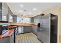 Contemporary kitchen boasting sleek gray cabinetry, stainless steel appliances, and butcher block countertops at 4932 Forest Oaks Dr, Las Vegas, NV 89149