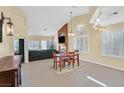 Open-concept living and dining area with vaulted ceilings, natural light, and fireplace feature at 4932 Forest Oaks Dr, Las Vegas, NV 89149