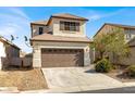 Inviting two-story home featuring a neutral color scheme and a convenient two-car garage at 5120 First Sun St, North Las Vegas, NV 89081