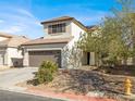 Attractive two-story home showcasing a desert landscape, two-car garage and charming shutters at 5120 First Sun St, North Las Vegas, NV 89081