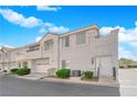 Attractive two-story townhome featuring a two-car garage and welcoming front door at 5201 S Torrey Pines Dr # 1223, Las Vegas, NV 89118