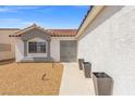 Single-story home with a terra cotta roof, desert-friendly front yard landscaping, and a front walkway at 5227 Zebra Ct, North Las Vegas, NV 89031