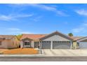 Charming single-story home featuring a terra cotta roof, two-car garage, and low-maintenance landscaping at 5227 Zebra Ct, North Las Vegas, NV 89031