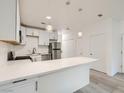 Well-lit kitchen with stainless steel appliances, modern cabinets and breakfast bar seating at 5415 W Harmon Ave # 1074, Las Vegas, NV 89103