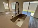 Modern kitchen featuring stainless steel sink with a large window and glass sliding door at 545 Thea St # 1315, Henderson, NV 89052