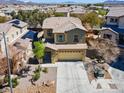 Aerial view of a two-story home in a suburban neighborhood with lush landscaping and a two-car garage at 5808 Sierra Cliff St, North Las Vegas, NV 89031