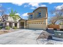 Charming two-story home featuring a well-maintained front yard and a spacious two-car garage at 5808 Sierra Cliff St, North Las Vegas, NV 89031
