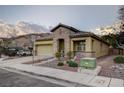 Attractive single-story house with stone accents, an attached garage, and low-maintenance landscaping at 6077 Honeysuckle Ridge St, Las Vegas, NV 89148