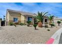 Single story home features desert landscaping with multiple palm trees at 6971 Moaning Cavern St, Las Vegas, NV 89131